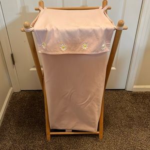 Light pink canvas laundry bag with wood holder.